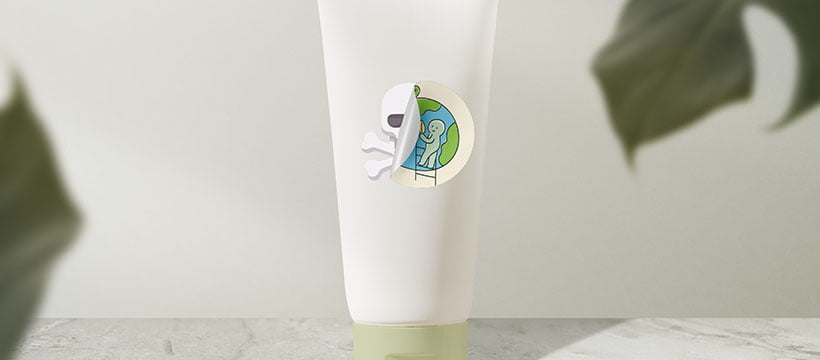 Embalagem branca sobre uma mesa com uma etiqueta adesiva de planeta Terra descolando e por baixo da etiqueta tem uma caveira que representa o greenwashing nas embalagens de produtos.